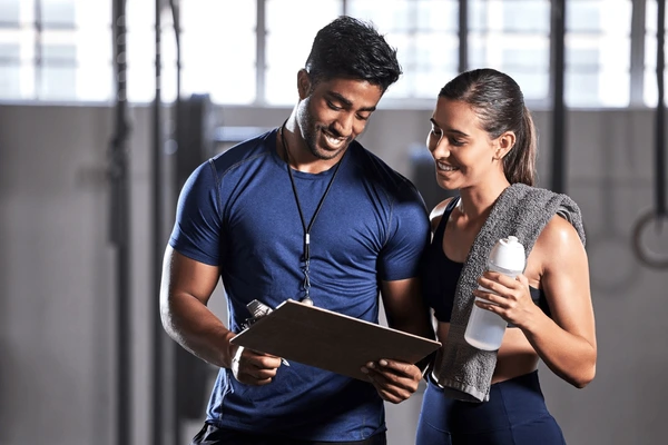 gym-subscription-personal-trainer-happy-600nw-2191542161