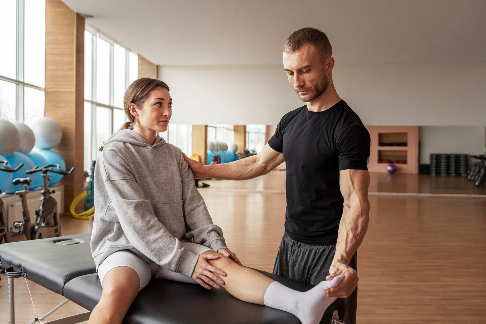 patient-doing-physical-rehabilitation-helped-by-therapists